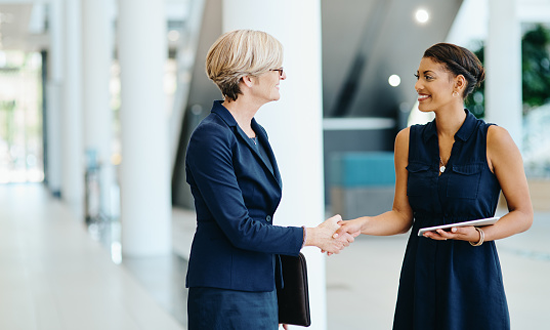 Business women shaking hands